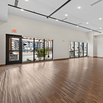 an empty living room with a wood floor and a door to a building at Yellowstone Landing, Montana, 59714